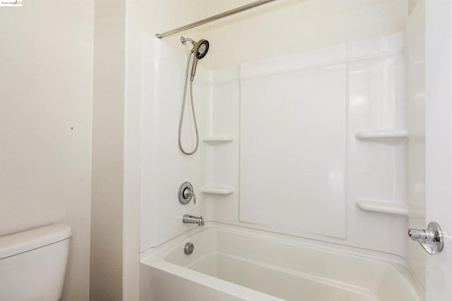 bathroom with shower / bathing tub combination and toilet