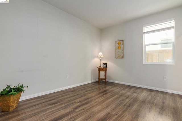 empty room with dark wood-type flooring