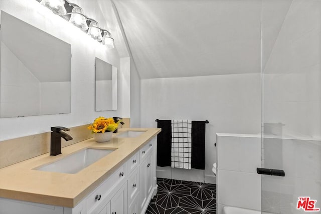 bathroom with dual vanity, tile floors, toilet, and vaulted ceiling