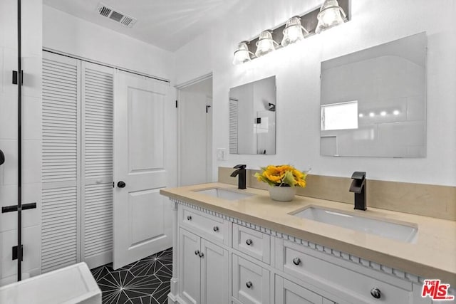 bathroom with double sink vanity and tile floors