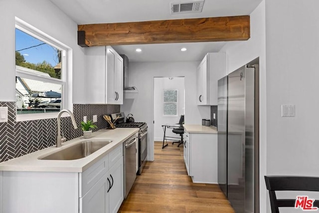 kitchen featuring sink, stainless steel appliances, light hardwood / wood-style floors, and white cabinets