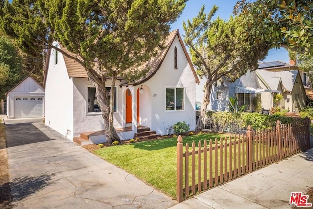 tudor-style house with a front lawn and a garage