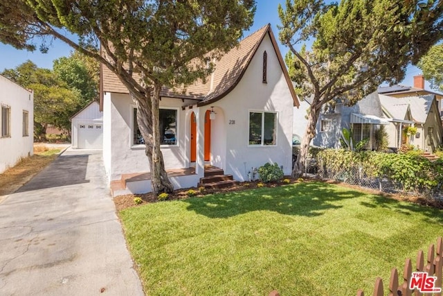 tudor-style house with a front lawn and a garage