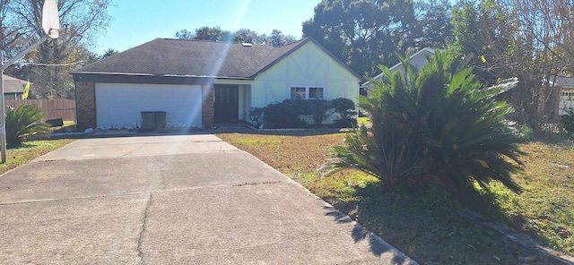 6567 NE Montrose Trl, Tallahassee, FL 32309 - view of front facade with a garage, concrete driveway, and fence