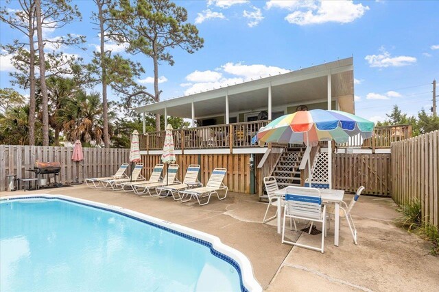 549 E Gulf Beach Dr, Saint George Islan, FL 32328 - community pool featuring a patio, a fenced backyard, and stairway