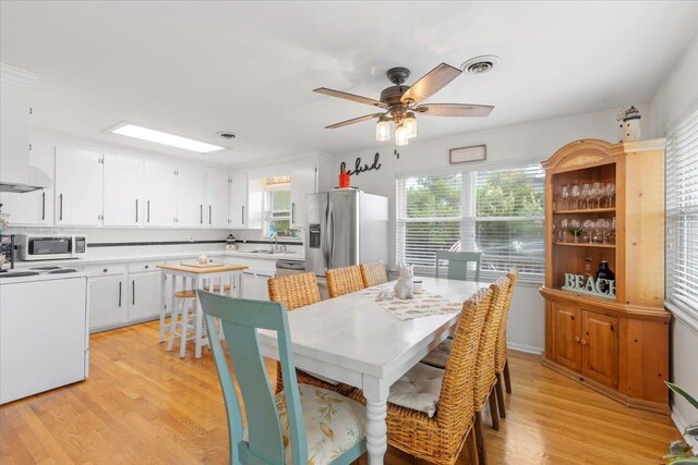 549 E Gulf Beach Dr, Saint George Islan, FL 32328 - dining area featuring healthy amount of natural light, light wood-type flooring, and a ceiling fan