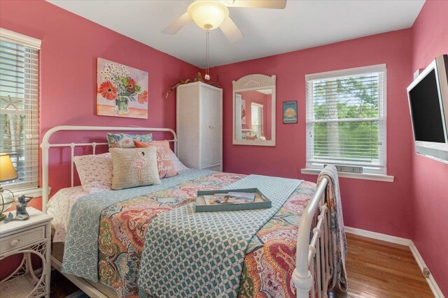 549 E Gulf Beach Dr, Saint George Islan, FL 32328 - bedroom with wood finished floors, baseboards, and ceiling fan