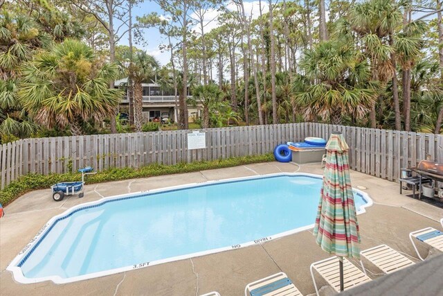 549 E Gulf Beach Dr, Saint George Islan, FL 32328 - community pool with a fenced backyard and a patio