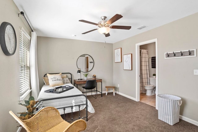 carpeted bedroom with ceiling fan and ensuite bathroom