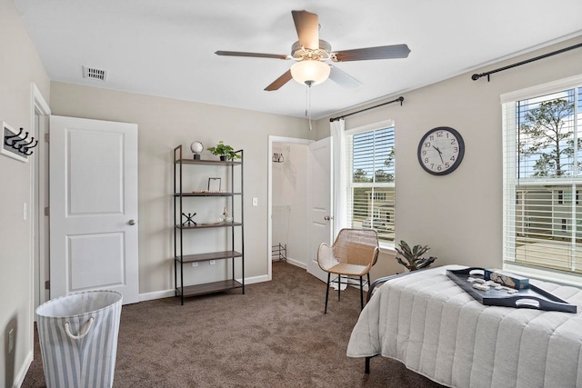 bedroom with ceiling fan and dark carpet