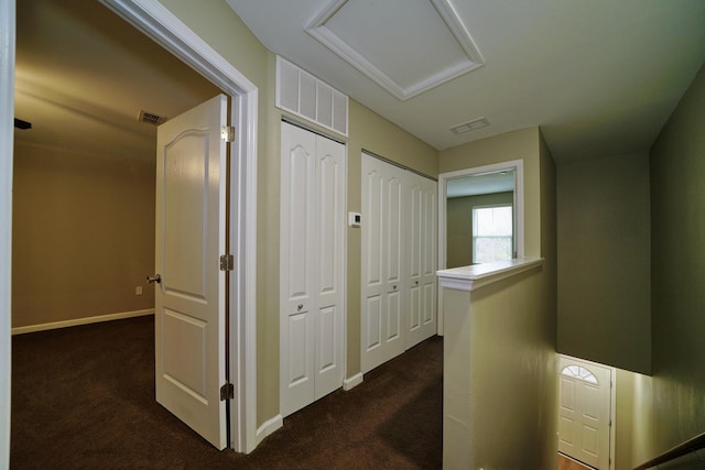 corridor with dark colored carpet