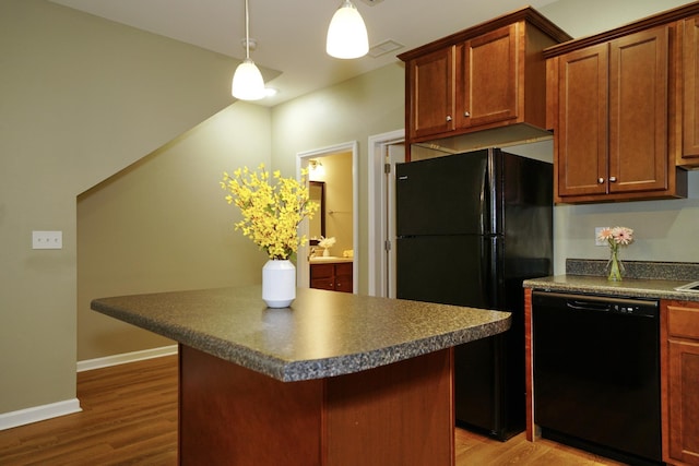 kitchen with black appliances, a center island, wood-type flooring, and pendant lighting