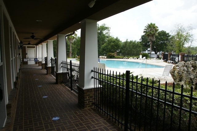 view of swimming pool featuring ceiling fan