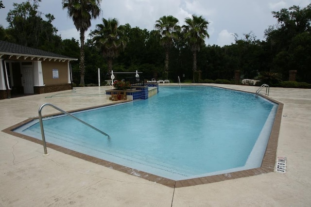 view of swimming pool featuring a patio area