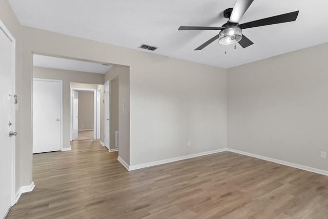 spare room with ceiling fan and light wood-type flooring