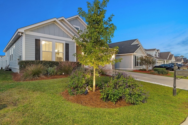 view of front of home with a garage and a front lawn