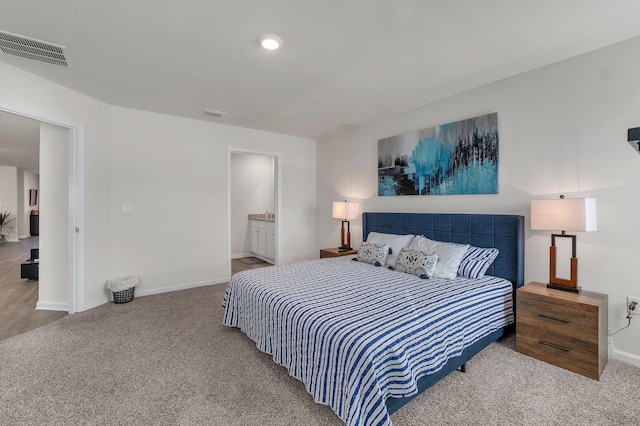 bedroom featuring carpet flooring and ensuite bath