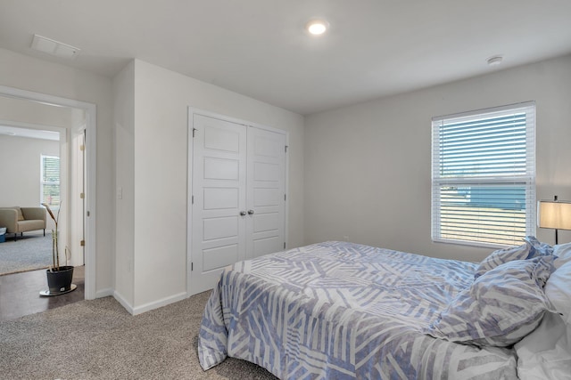 carpeted bedroom featuring a closet