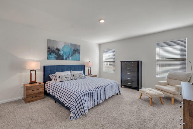 carpeted bedroom with multiple windows