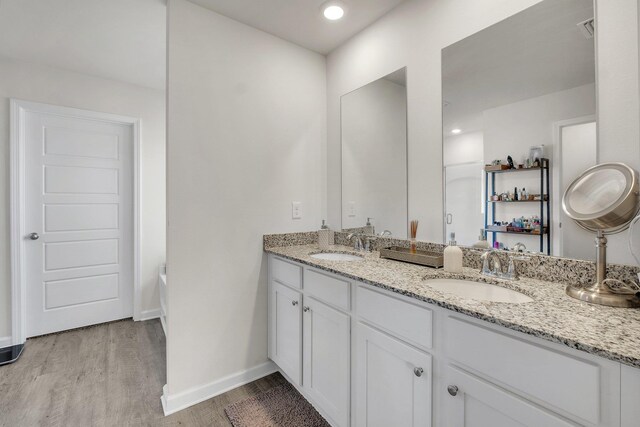 bathroom featuring a bathtub, hardwood / wood-style floors, and vanity