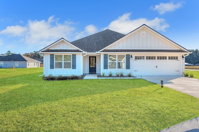 view of front of property featuring a front lawn and a garage