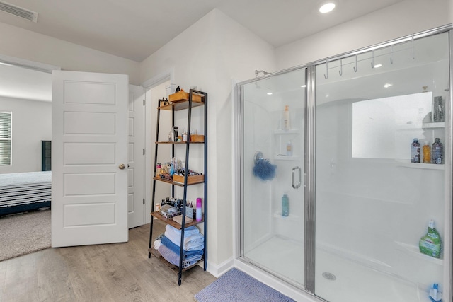 bathroom featuring an enclosed shower and hardwood / wood-style floors