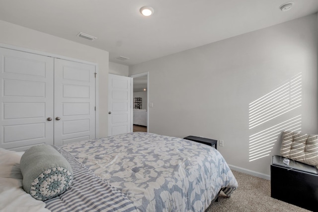 bedroom with light carpet and a closet