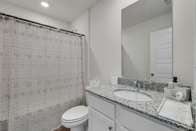 bathroom with curtained shower, toilet, and vanity