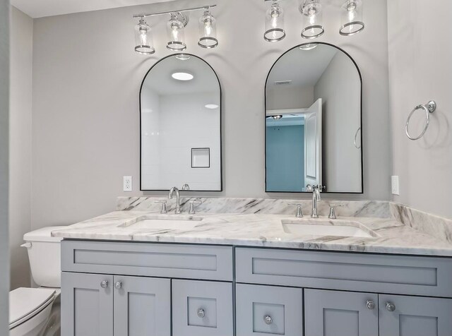 bathroom featuring vanity and toilet