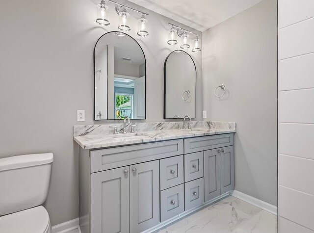 bathroom with toilet and vanity