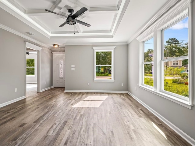 empty room with coffered ceiling, hardwood / wood-style flooring, ceiling fan, and crown molding