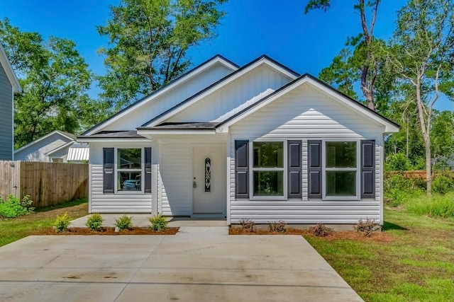 bungalow-style home with a front yard