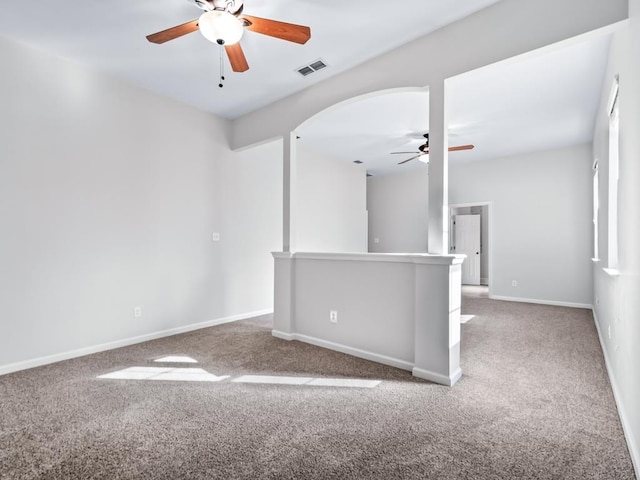 carpeted spare room featuring ceiling fan