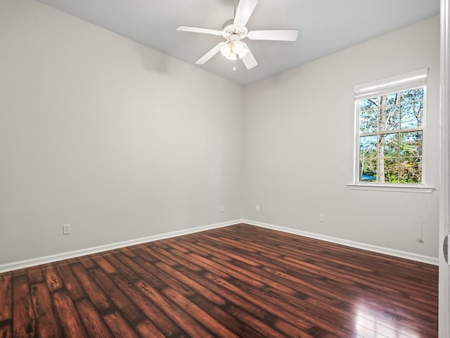 empty room featuring dark hardwood / wood-style flooring and ceiling fan