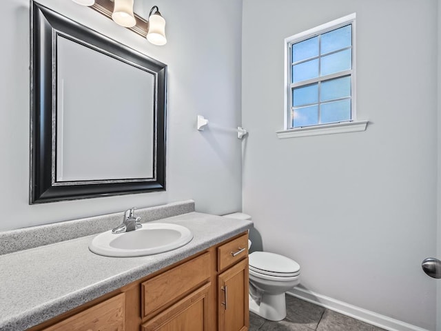 bathroom featuring tile patterned flooring, vanity, and toilet