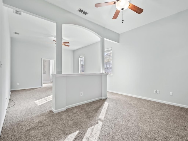 unfurnished room featuring ceiling fan and light colored carpet