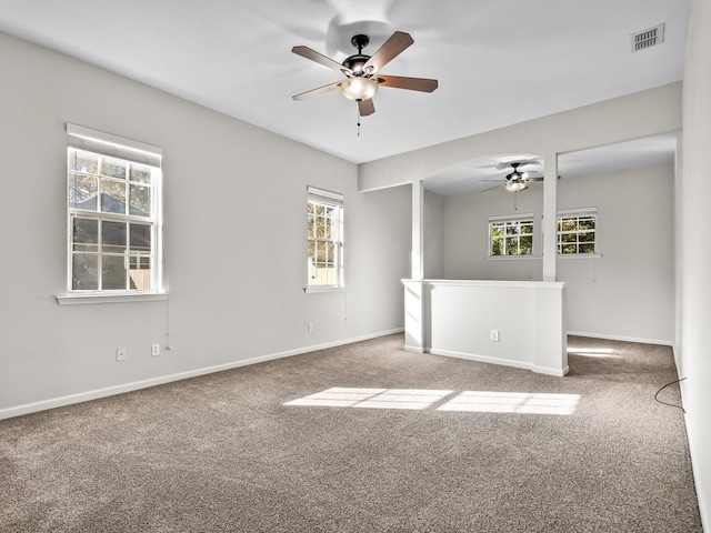 empty room with ceiling fan and carpet floors