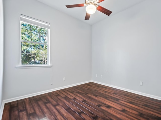 spare room featuring ceiling fan and dark wood-type flooring