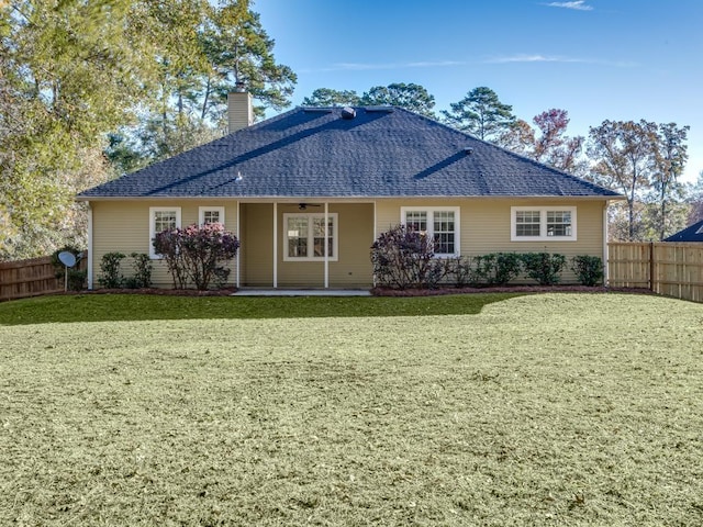 rear view of house with a lawn