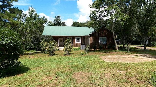 view of front of house featuring a front lawn and cooling unit