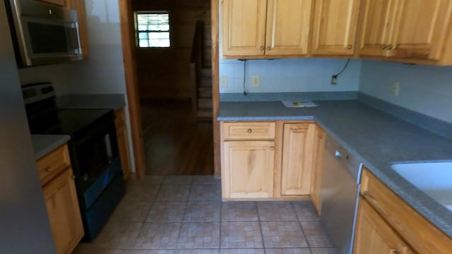 kitchen featuring dishwashing machine, light brown cabinets, electric range, and sink