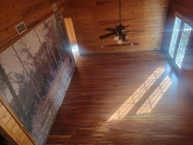 details featuring hardwood / wood-style floors, ceiling fan, and wood walls