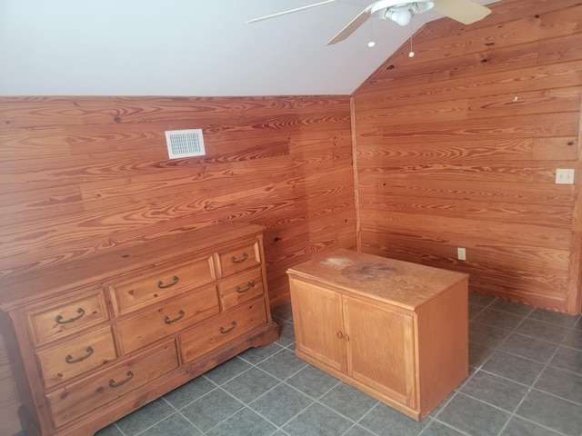 bathroom with wooden walls, ceiling fan, and lofted ceiling