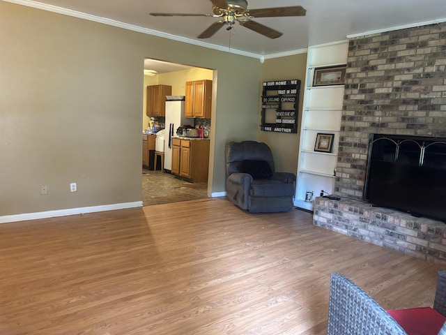 1208 Halifax Ct, Tallahassee, FL 32308 - living room with a ceiling fan, ornamental molding, a brick fireplace, and light wood-style flooring