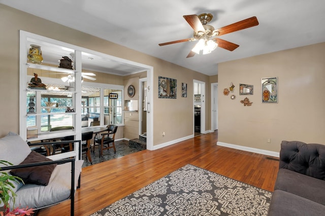 living room featuring ceiling fan and hardwood / wood-style floors