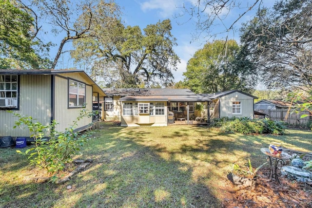 back of property featuring cooling unit and a yard