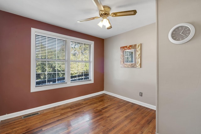 unfurnished room featuring ceiling fan and dark hardwood / wood-style flooring