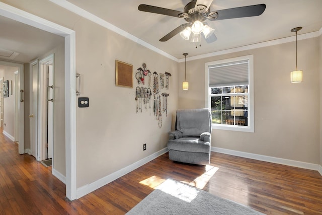 living area featuring ceiling fan, dark hardwood / wood-style flooring, and crown molding