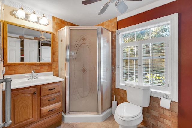 bathroom with toilet, vanity, tile patterned flooring, and a shower with door