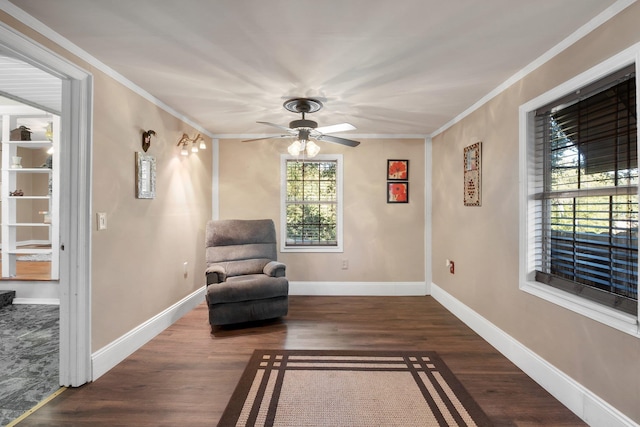 living area with ceiling fan, dark hardwood / wood-style flooring, and ornamental molding